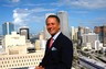 Attorney Dan Weiss enjoys the view from the balcony of the offices of Tannebaum Weiss, PL, in the penthouse of the Museum Tower, 150 West Flagler Street, in Miami.